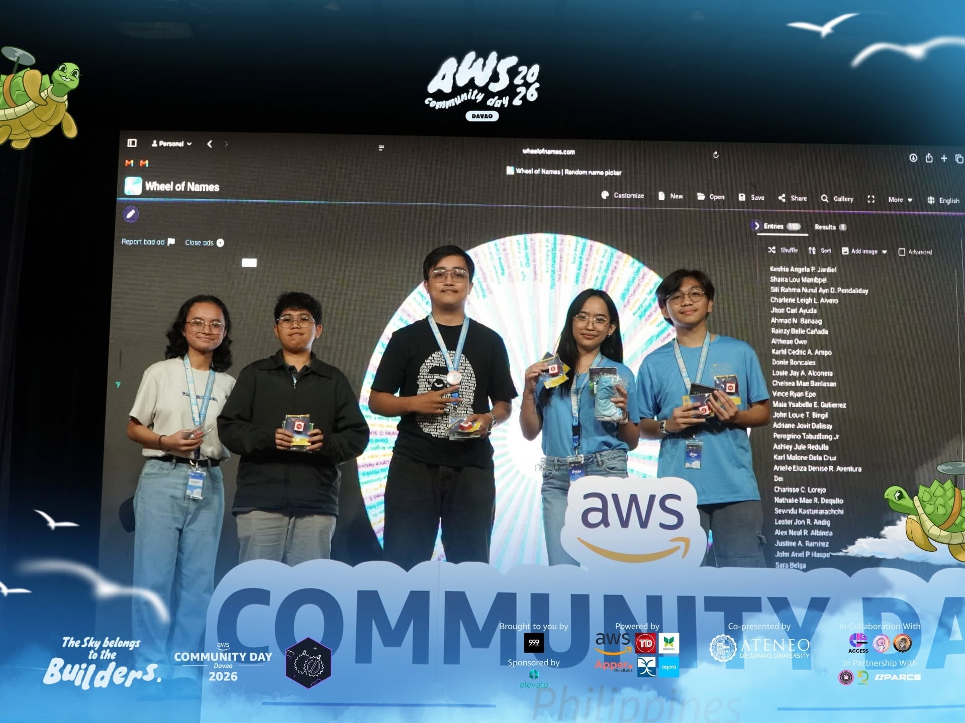 AWS Community Day raffle winners on stage with prizes